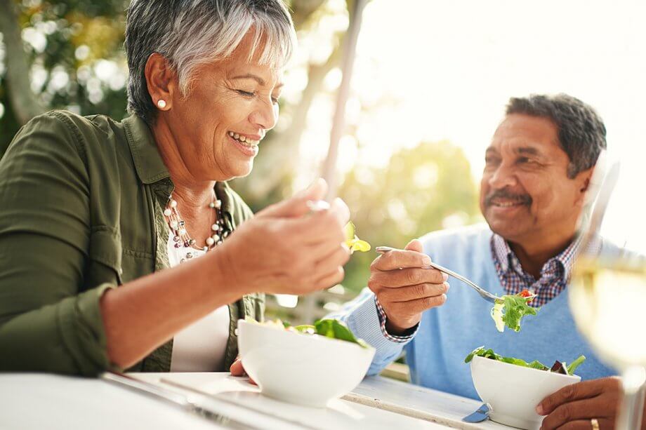 Man and woman eating salads